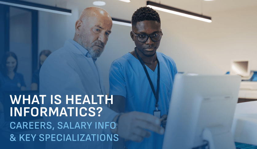 two male healthcare workers look at a computer screen together in a hospital setting