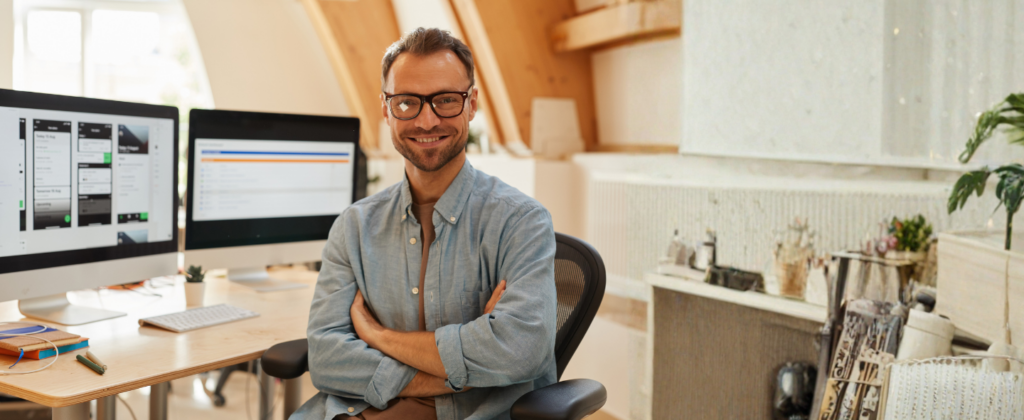 UX/Learning Designer working from home with computer monitors behind him