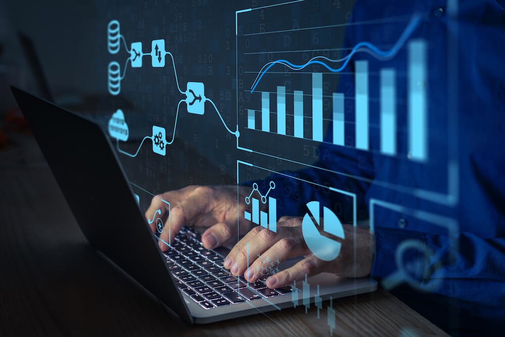 a man typing on a laptop with a graphics of data visualization over his hands