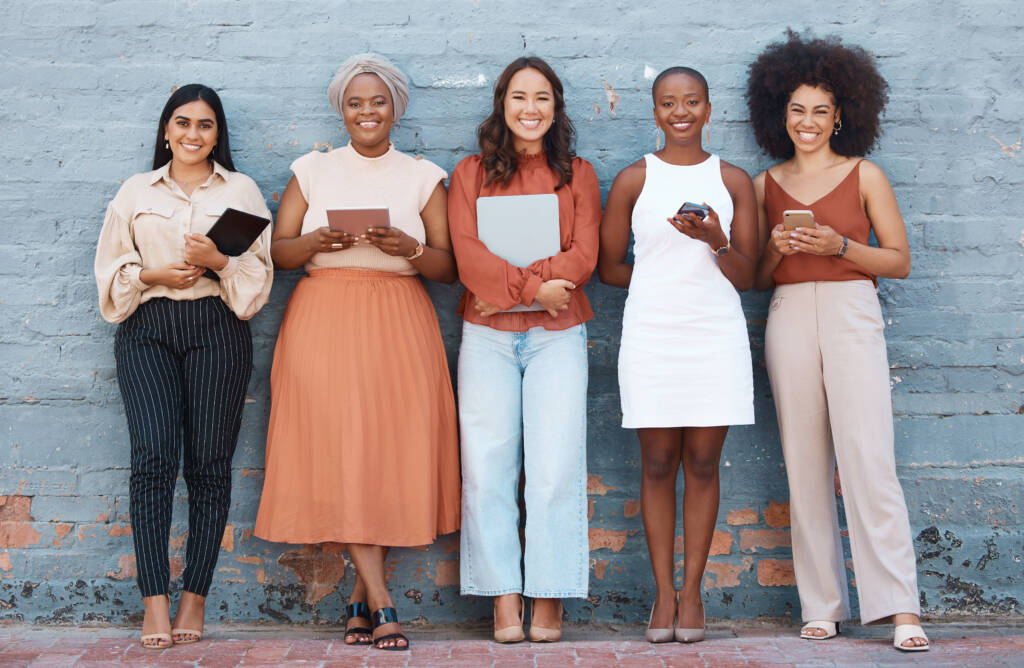 Group of smiling diverse women in a row
