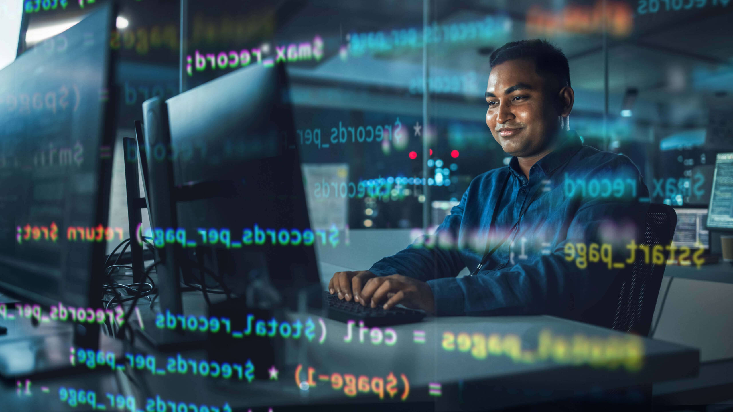 man typing code on computer