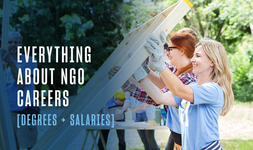 Two women helping build and put up a wall