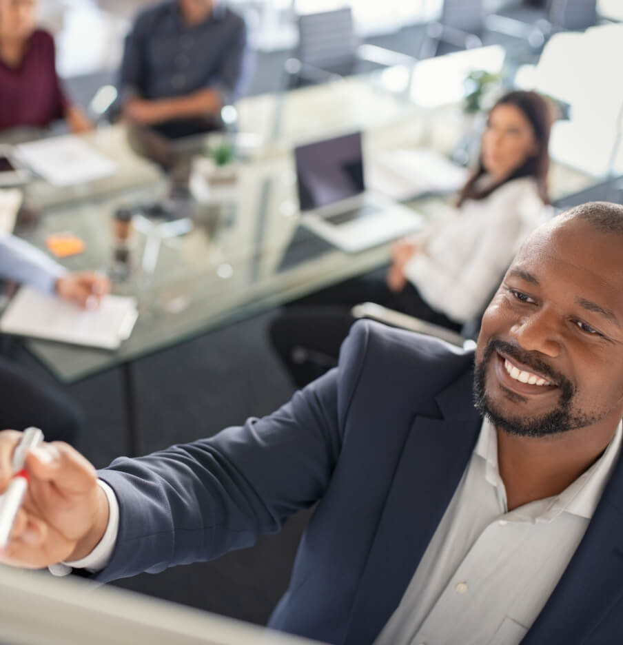 engineering-manager-smiling-handing-a-pen-to-a-co-worker.