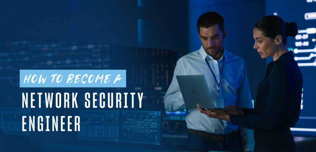 two IT professionals work together in a server room holding a laptop