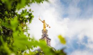 The gold coloured statue of Lady Justice, holding a sword and scales, on top of the dome of the Old Bailey, England's criminal court in the City of London.