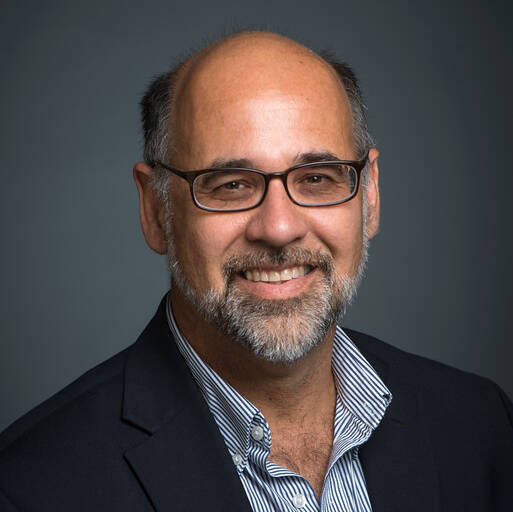 man wearing glasses and formal dress attire