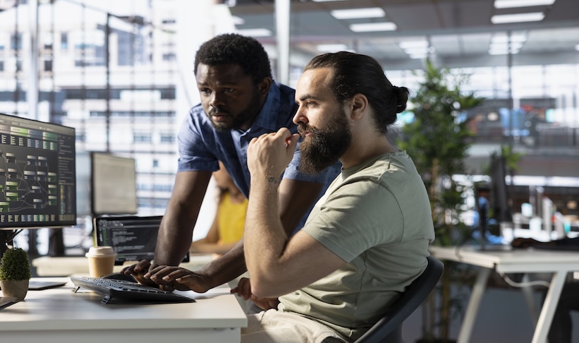 Developer requesting help from colleague while working with machine learning tech advancing AI critical to autonomous systems. IT expert and helpful coworker transforming data into predictive models