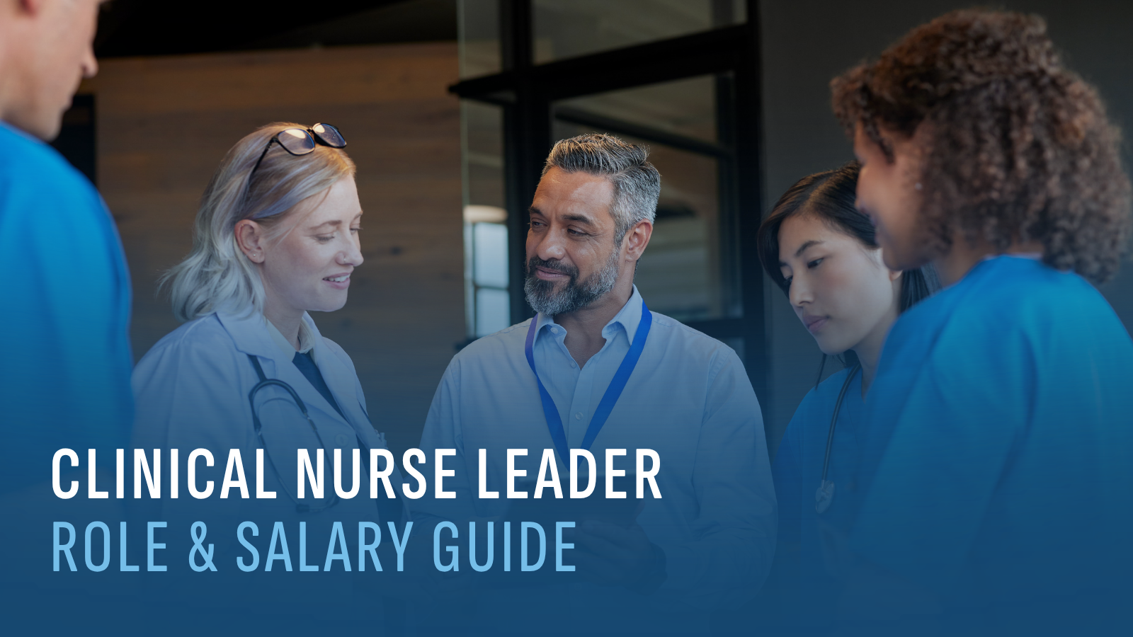 nurses next to a clinical nurse leader all looking at a tablet together.
