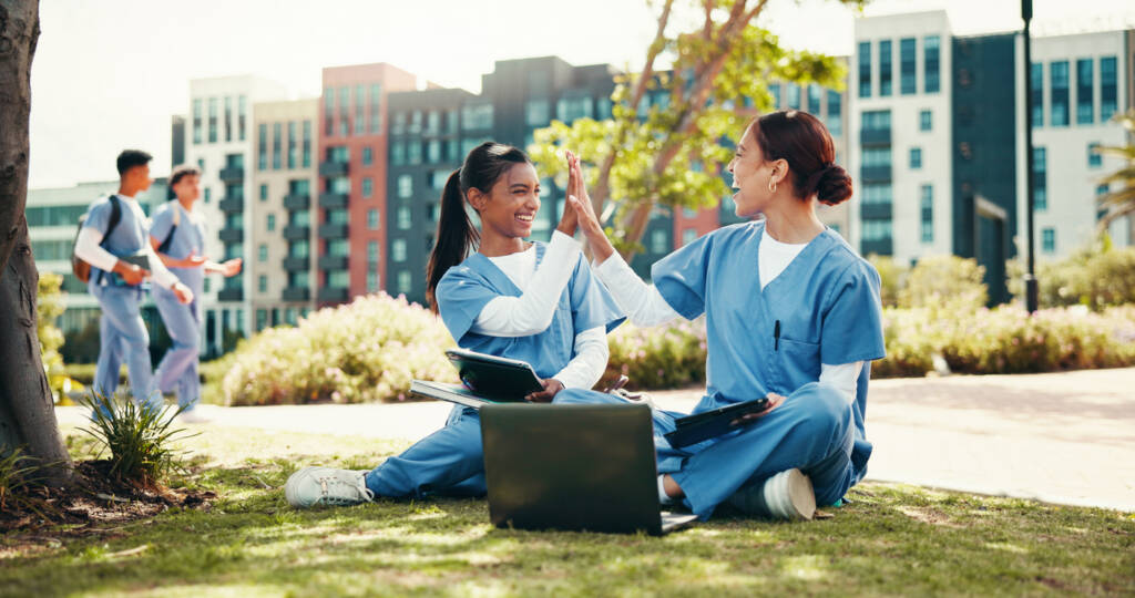 Happy women, nurse and high five with laptop for internship, medical study or winning at campus.