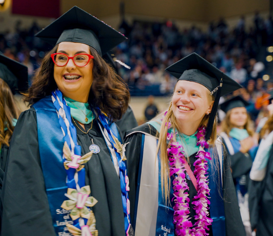 Two graduates of the MSNP program smiling at commencement 