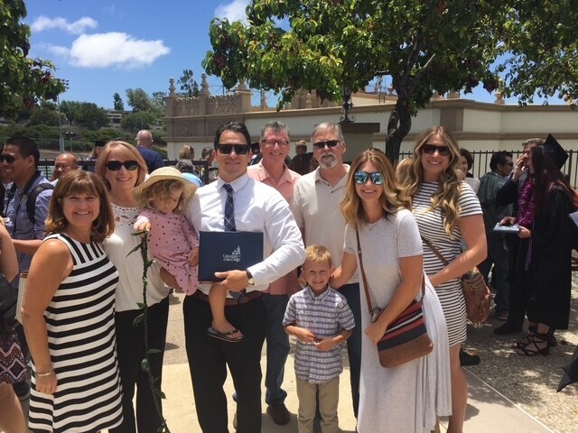 Ryan Opeka poses with his MS-LEPSL degree and family after a graduation ceremony at University of San Diego