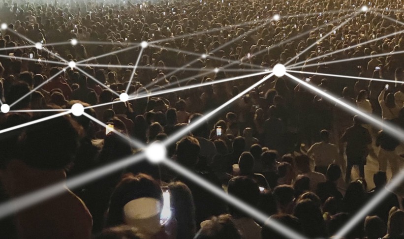 Crowd using cellphones at a concert connected by lines