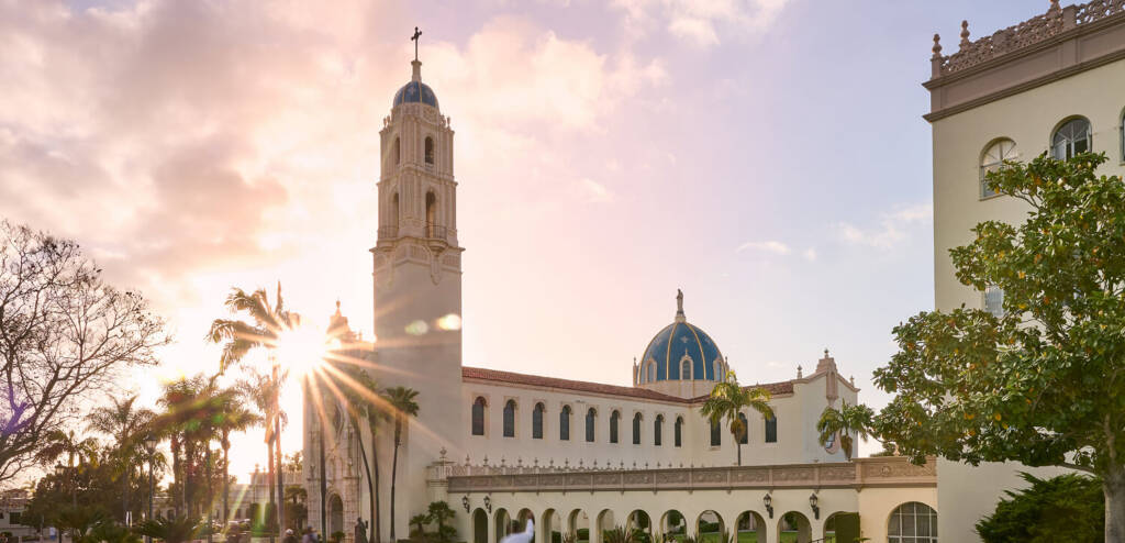 usd campus building with the sun rising behind it